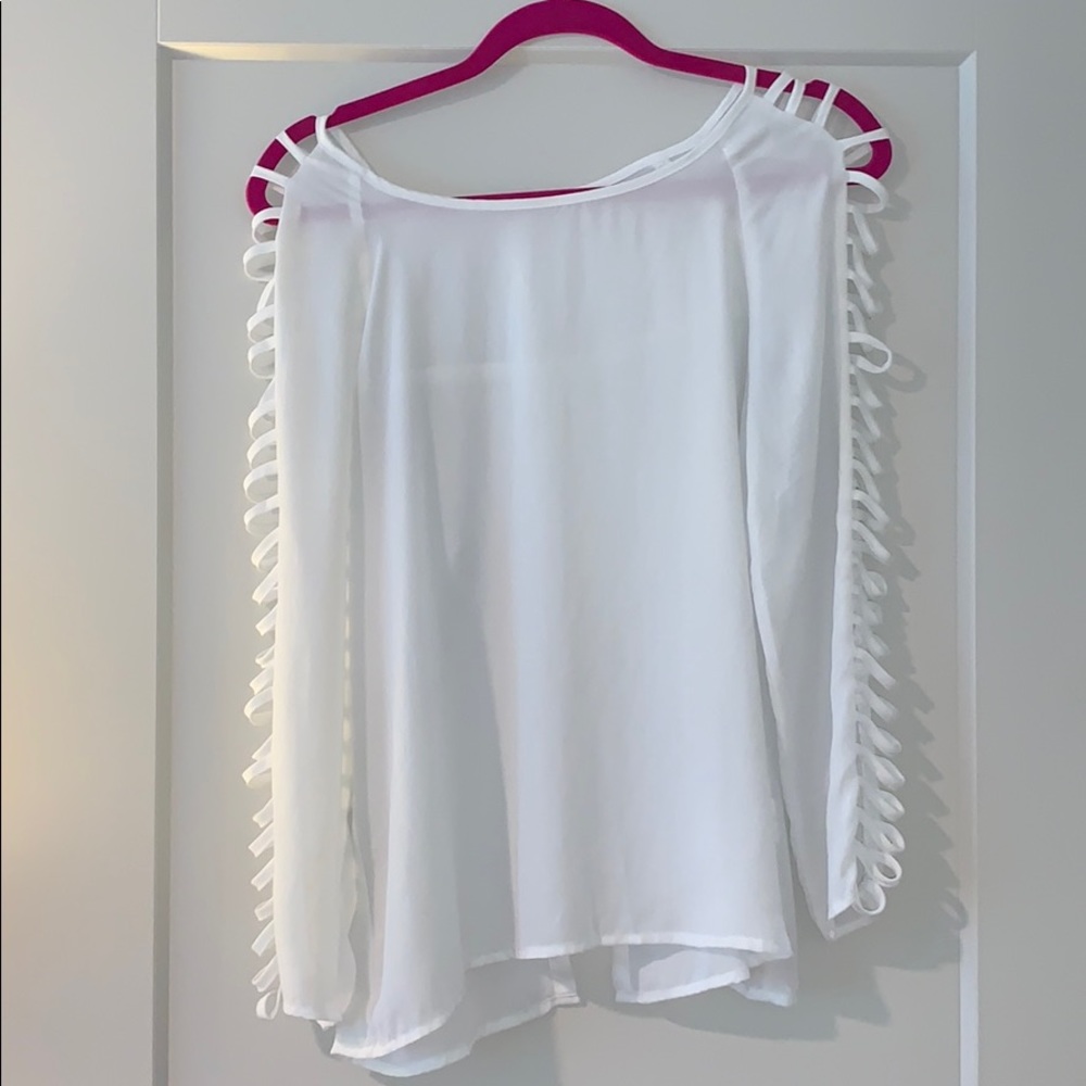 White blouse with arm cut outs & an open back
